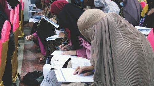 Afghan burqa-clad women take an entrance test at Mamon Tahiri insititute in Kandahar on September ...