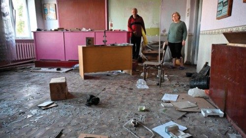 Employees clean a class room which was used by troops as their base in the village of Nova ...