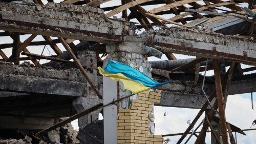 A Ukrainian national flag flutters on a damaged building in the town of Kupiansk, recently liberated ...