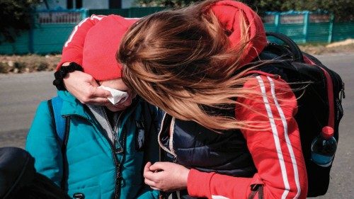 Twelve-year-old Lila (C) is comforted by her sister Yana (2ndR) as they look for a transport to ... Twelve-year-old Lila (C) is comforted by her sister Yana (2ndR) as they look for a transport to ...
