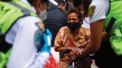 TOPSHOT - A woman receives medical care after an earthquake in Mexico City on September 19, 2022. - ...