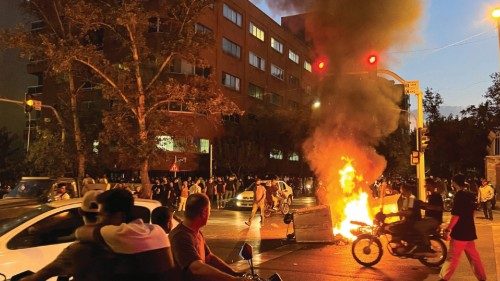 FILE PHOTO: A police motorcycle burns during a protest over the death of Mahsa Amini, a woman who ...