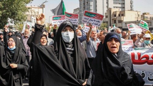 Women and men chant slogans as they march in a pro-hijab rally in Iran's capital Tehran on September ...