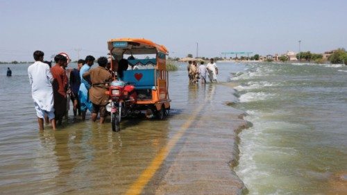 FILE PHOTO: Displaced people stand on flooded highway, following rains and floods during the monsoon ... FILE PHOTO: Displaced people stand on flooded highway, following rains and floods during the monsoon ...