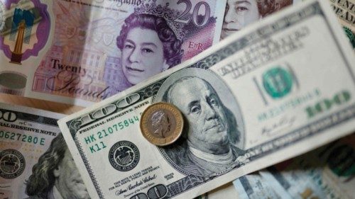 (FILES) This file photo taken on April 22, 2022 shows pounds and US dollar banknotes displayed on a ... (FILES) This file photo taken on April 22, 2022 shows pounds and US dollar banknotes displayed on a ...