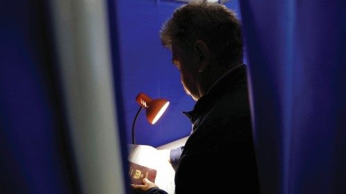 A voter stands inside a voting booth at a polling station during a referendum on the joining of the ...