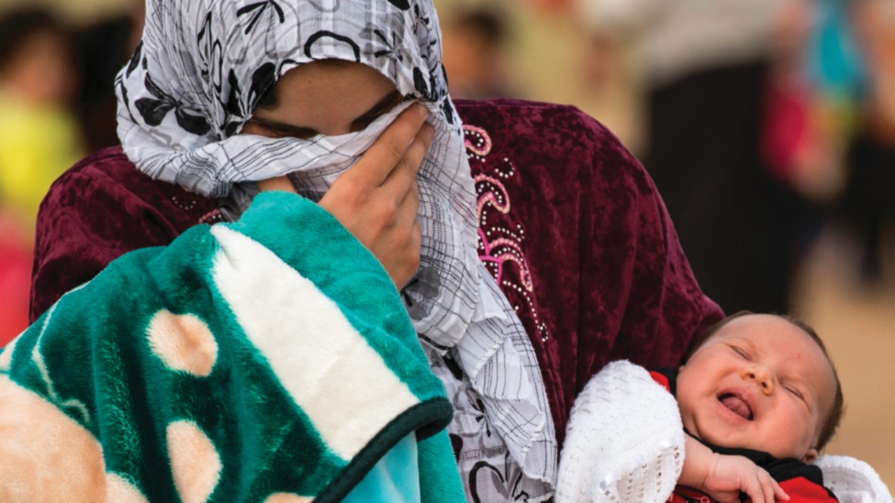 A young mother crosses the border from Syria and becomes a refugee. She carries her one-month-old ...