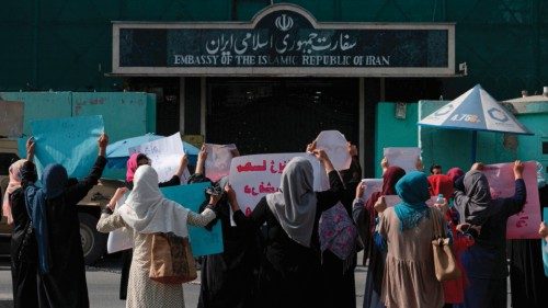 TOPSHOT - Afghan women hold placards as they take part in a protest in front of the Iranian embassy ...