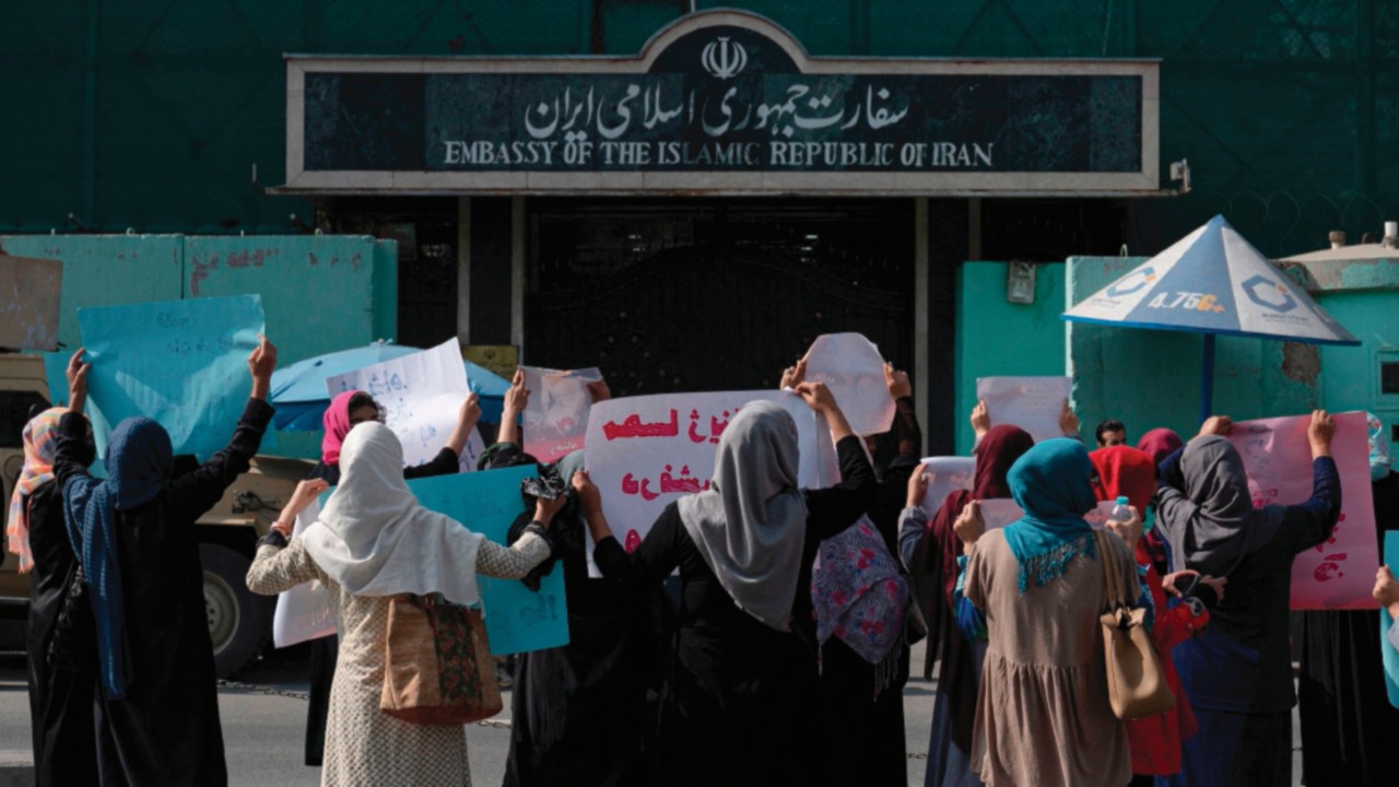 TOPSHOT - Afghan women hold placards as they take part in a protest in front of the Iranian embassy ...