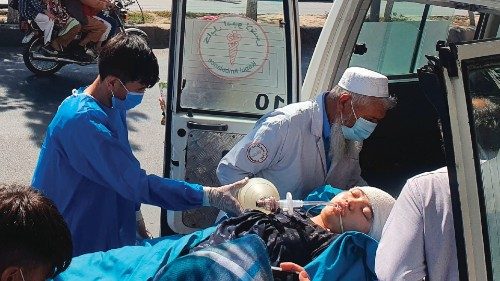 Relatives and medical staff shift a wounded girl from an ambulance outside a hospital in Kabul on ...