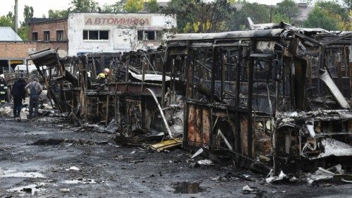 Damage is seen after a strike hit public transport depot, amid Russia's attack on Ukraine, in ...