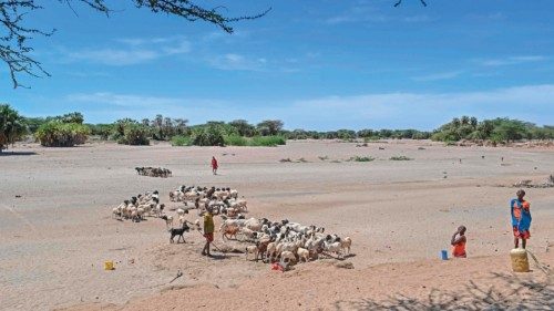 Patoralists from the Turkana community water goats from a shallow well dug into a dry riverbed at ...