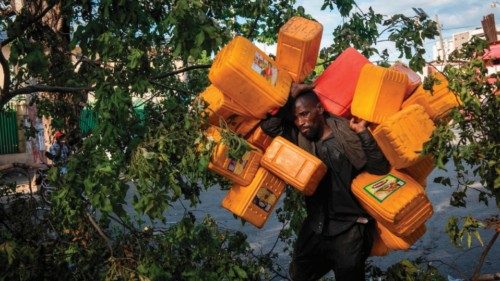 epaselect epa10212529 A man carries several buckets to stock up on fuel during the strike against ...