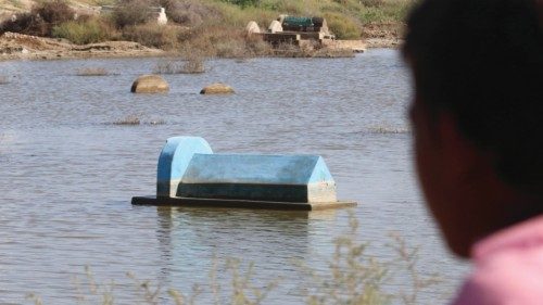 epa10214829 A man looks at a graveyard submerged in flood water in Matiyari district, Sindh ...