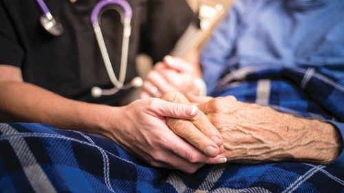 A stock photo of a Hospice Nurse visiting an Elderly male patient who is receiving ...