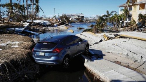 A car is seen on the destroyed road between Matlacha and Pine Island after Hurricane Ian caused ...