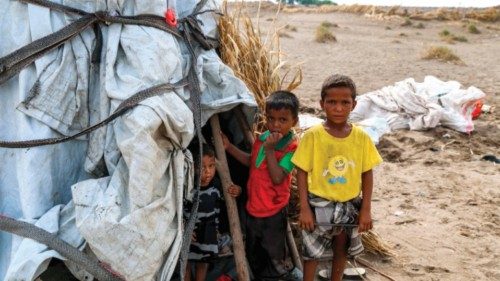 (FILES) In this file photo taken on August 19, 2022 children stand outside a tent at a camp for the ...