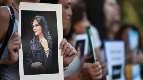 epa10219773 A Lebanese activist holds a poster depicting deceased Mahsa Amini during a protest ...