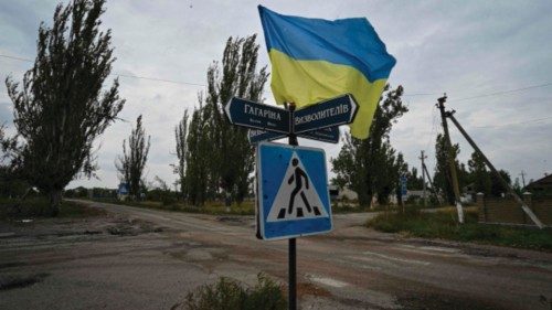 TOPSHOT - A photograph taken on September 27, 2022, shows Ukrainian flag waves on a street of the ...