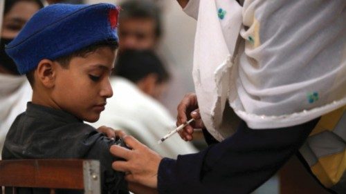 epa10224380 A health worker administers a dose of a vaccine to school children during a 13-day long ...