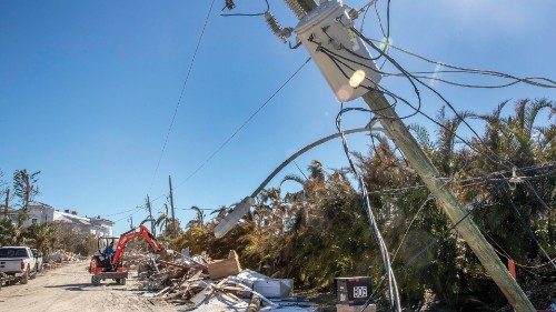 epa10220495 An excavator picks up debris in front of a downed power pole in San Carlos Island after ...