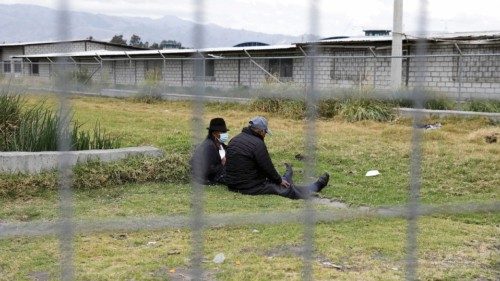 Family members of inmates sit outside the Cotopaxi No 1 penitentiary where several people have been ...