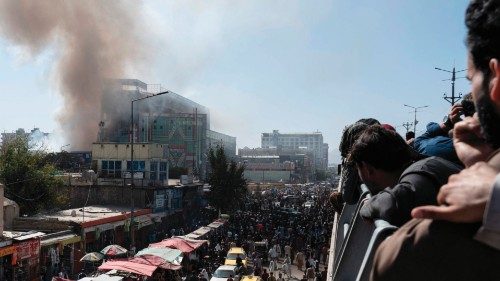 People watch smoke billowing from a fire at a business centre mall in Kabul on October 5, 2022. ... People watch smoke billowing from a fire at a business centre mall in Kabul on October 5, 2022. ...