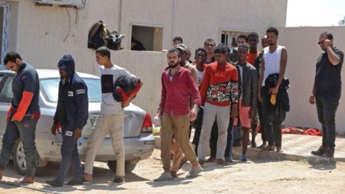 Migrants who were detained by Libyan authorities on a boat off the coast are held ahead of their ... Migrants who were detained by Libyan authorities on a boat off the coast are held ahead of their ...