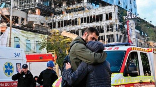 TOPSHOT - People react outside a partially destroyed multistorey office building after several ...