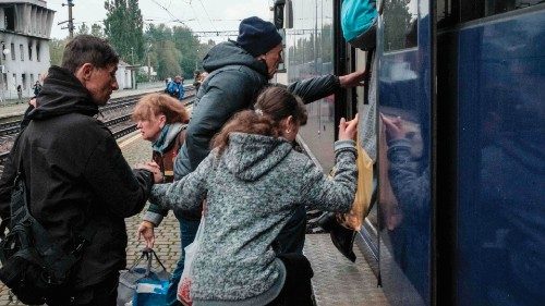 Thirteen year-old Maryna (R) and her father Yury (2L) ride a train to see Yury's sister as the ...