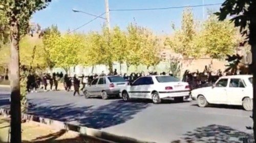 Protesters donning black march down the street following the death of Mahsa Amini in Saqez in ... Protesters donning black march down the street following the death of Mahsa Amini in Saqez in ...