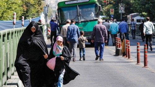 A woman and a girl walk on their way for the weekly Muslim Friday prayers in Iran's capital Tehran ...