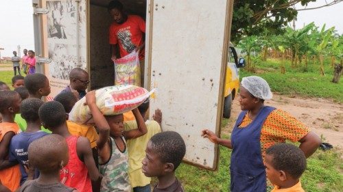 Pupils help to offload food items at the Kyerekrom DA primary school as the Food For All Africa ...