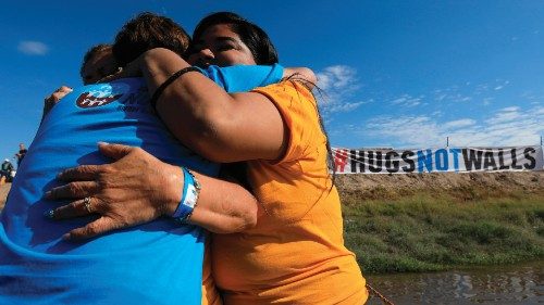 epa10245995 Migrant families gathered during the 'Hugs, not walls' meeting, on the edge of the Rio ...