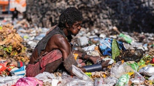 A man looks for food through piles of trash on the side of a street in Port-au-Prince, Haiti October ...