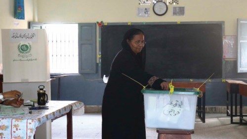 epa10247219 A woman casts her ballot at a polling station during by-elections in Karachi, Sindh ...