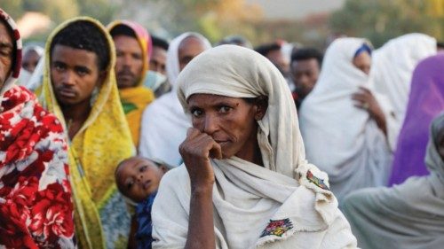 FILE PHOTO: A woman stands in line to receive food donations, at the Tsehaye primary school, which ... FILE PHOTO: A woman stands in line to receive food donations, at the Tsehaye primary school, which ...