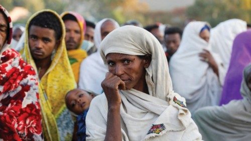 FILE PHOTO: A woman stands in line to receive food donations, at the Tsehaye primary school, which ...