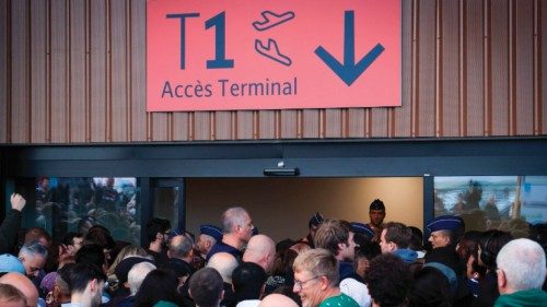 Passengers queue outside the terminal building during a strike by the 'Security Master' safety ...