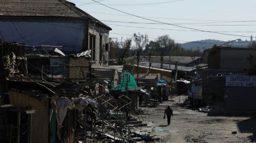 A man walks through a shopping street destroyed by Russian strikes, amid Russia's attack on Ukraine, ...