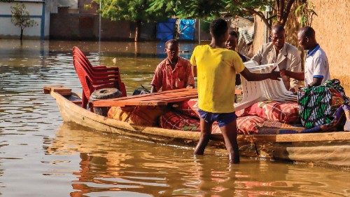 Residents try to salvage items from houses submerged by floods in N'Djamena on October 18, 2022. - ...