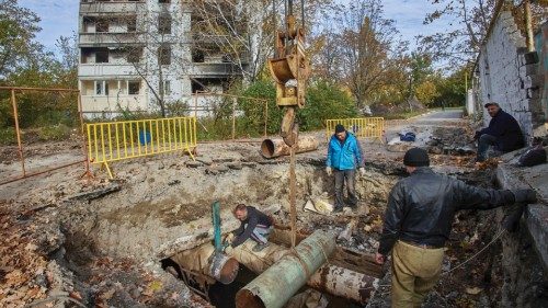 epa10252916 Ukrainian workers repair damaged heating communications of damaged residential buildings ...