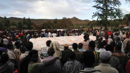 FILE PHOTO: People stand in line to receive food donations, at the Tsehaye primary school, which was ... FILE PHOTO: People stand in line to receive food donations, at the Tsehaye primary school, which was ...