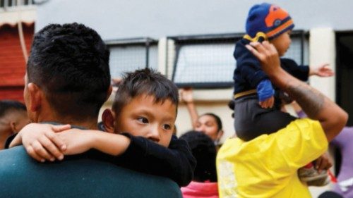 Latin American migrants, most of them from Venezuela, queue to receive donated clothes at Cafemin ...