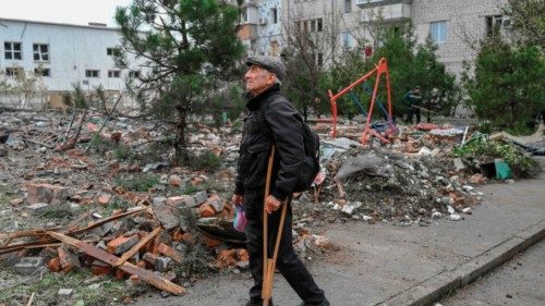 TOPSHOT - An man stands in a street after a rocket attack in Mykolaiv on October 23, 2022 during the ...