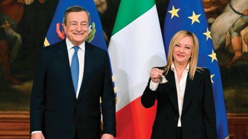 Italy's outgoing Prime Minister Mario Draghi (L) hands over the bell used by the cabinet president ...