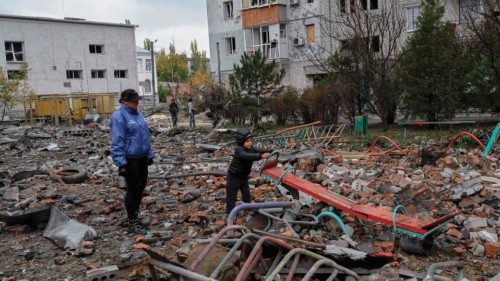 A children tries to play in the middle of rubbles as his mother stands next to him after a rocket ... A children tries to play in the middle of rubbles as his mother stands next to him after a rocket ...