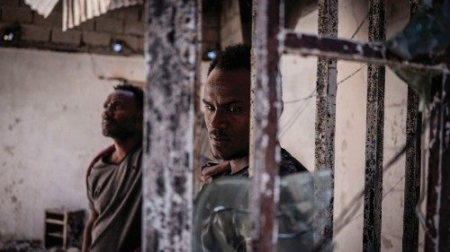 TOPSHOT - A man looks on at a burned warehouse, allegedly looted by Tigray rebels in Shewa Robit, ...