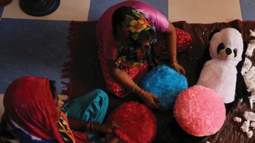 Women workers make soft toys using recycled fibre separated from cigarette filter tips at a ...