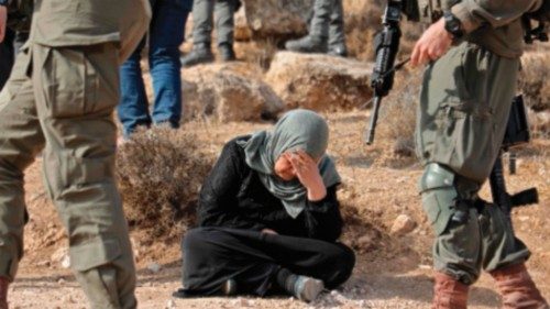 A woman reacts as Israeli forces demolish a Palestinian-owned building in the West Bank village of ...